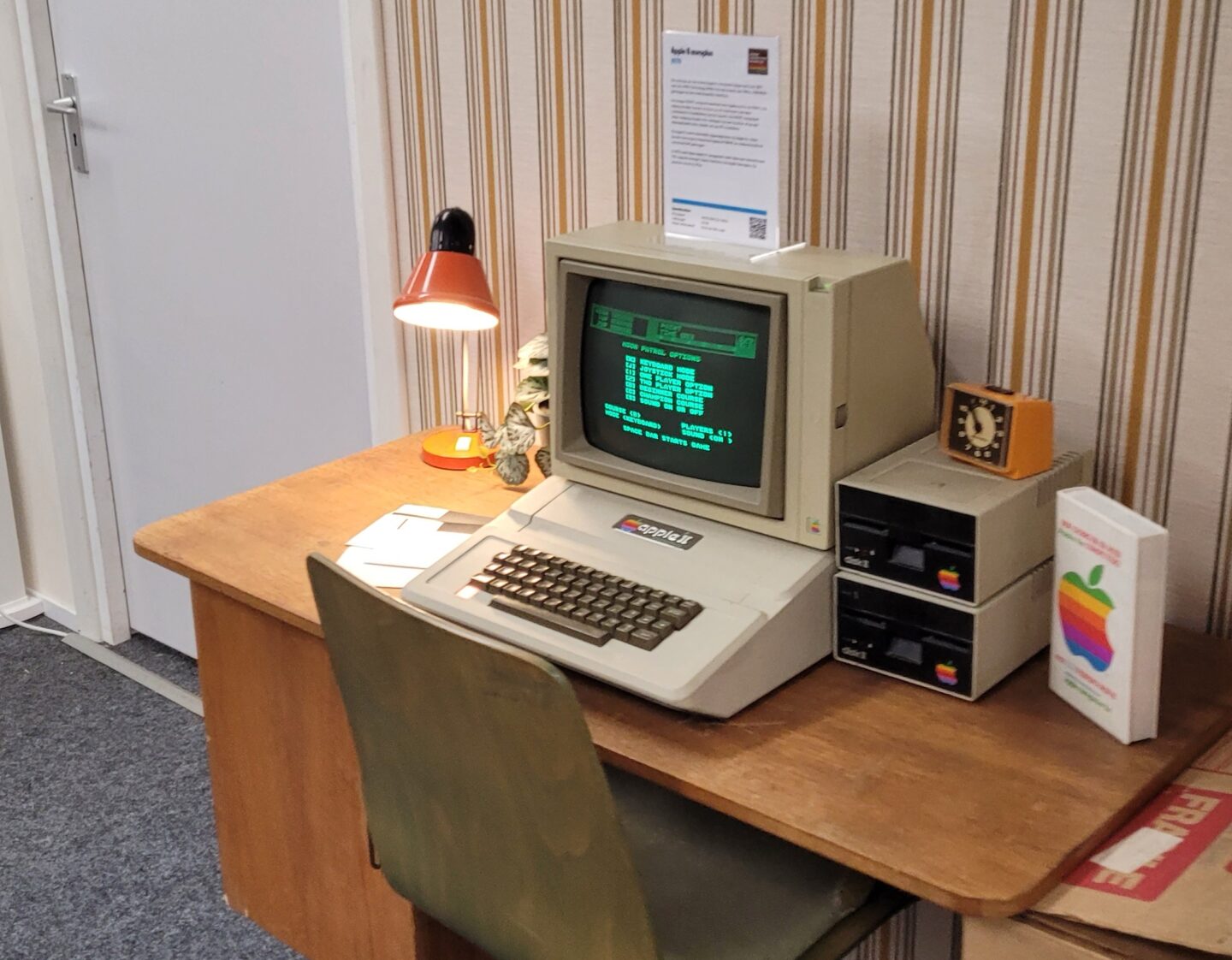 Apple II computer and Monitor II with two Disk II drives, sitting at a desk