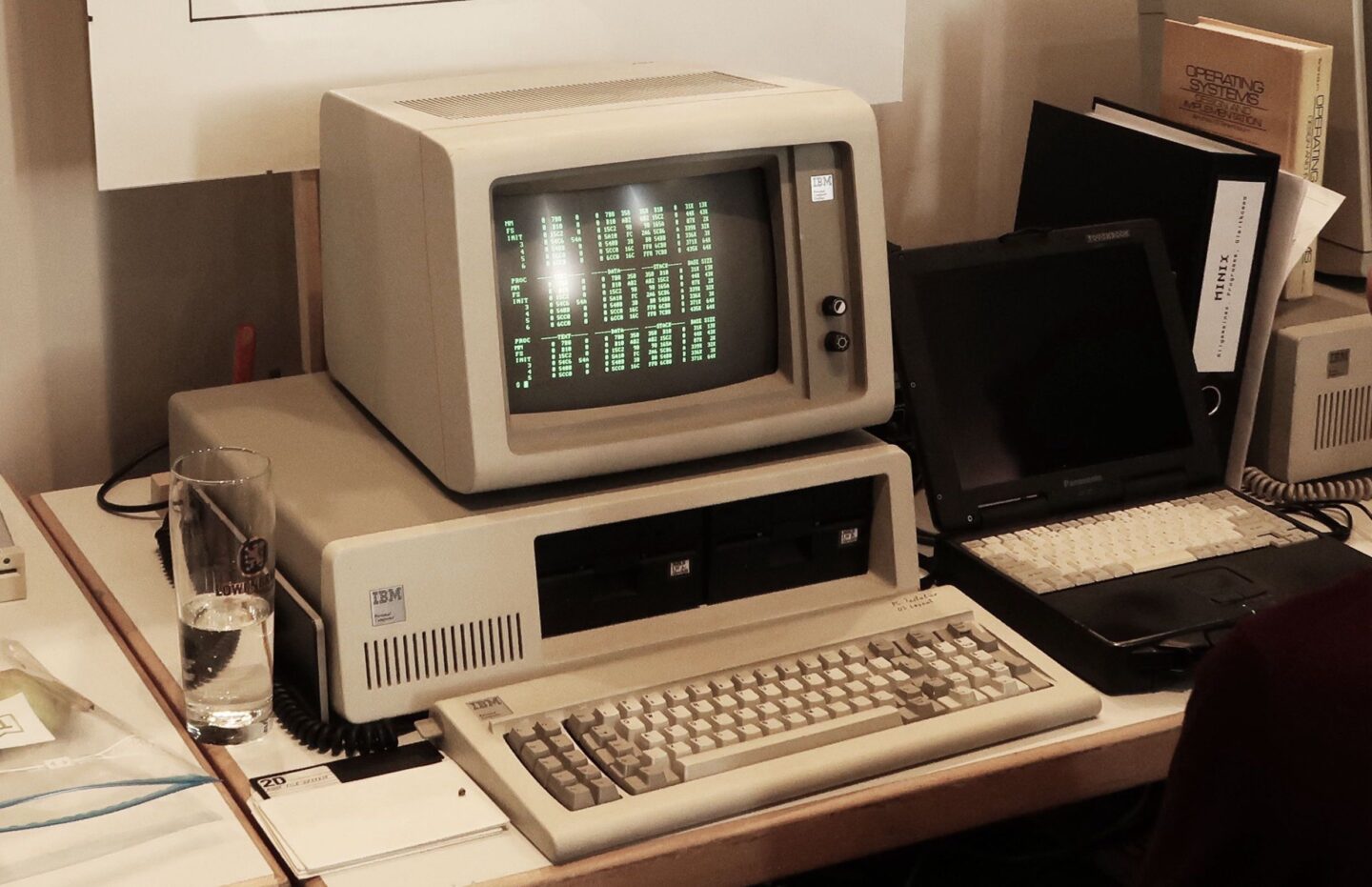 IBM PC with its matching green monochrome monitor on a desk displaying some numerical data