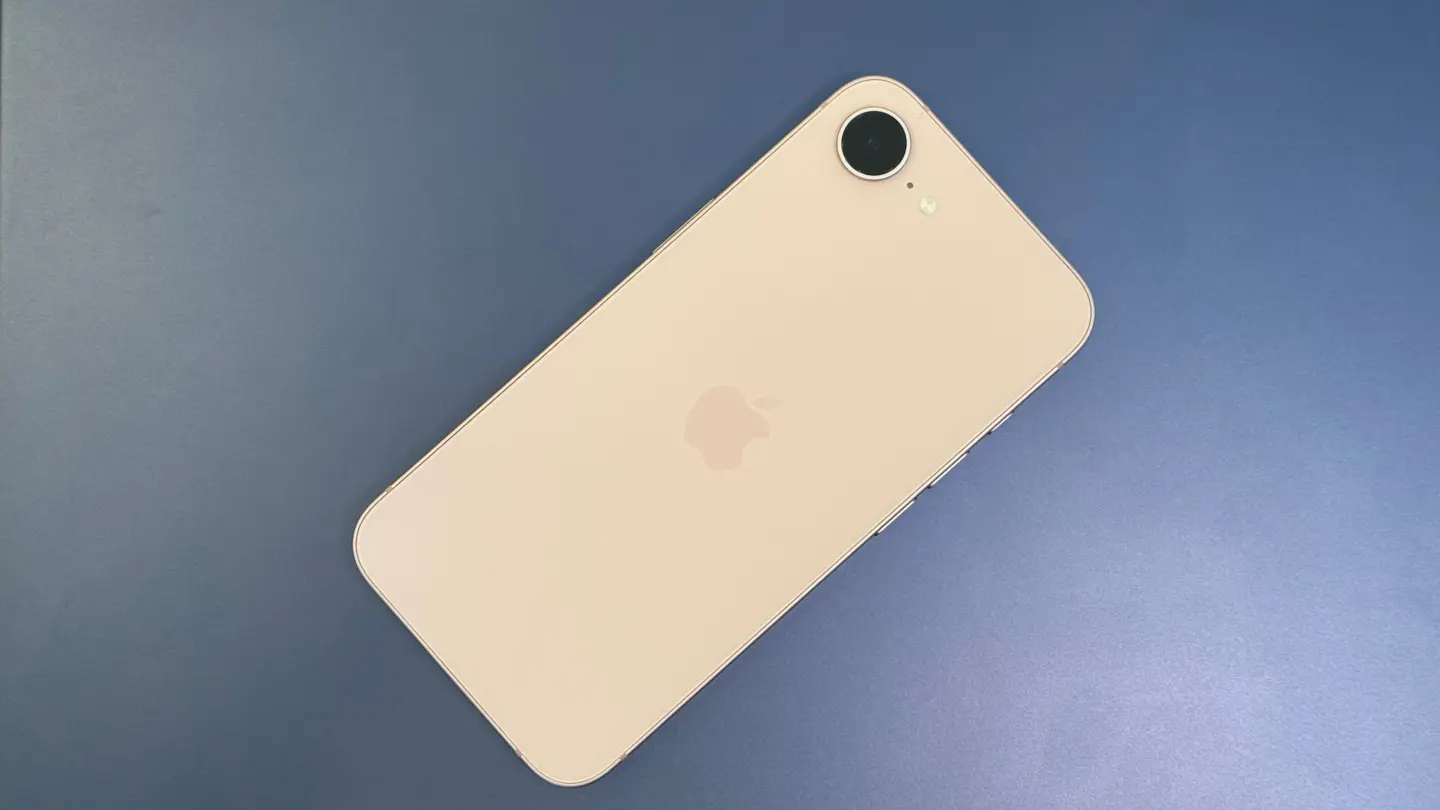 Pink iPhone 17e sitting on a blue shiny background