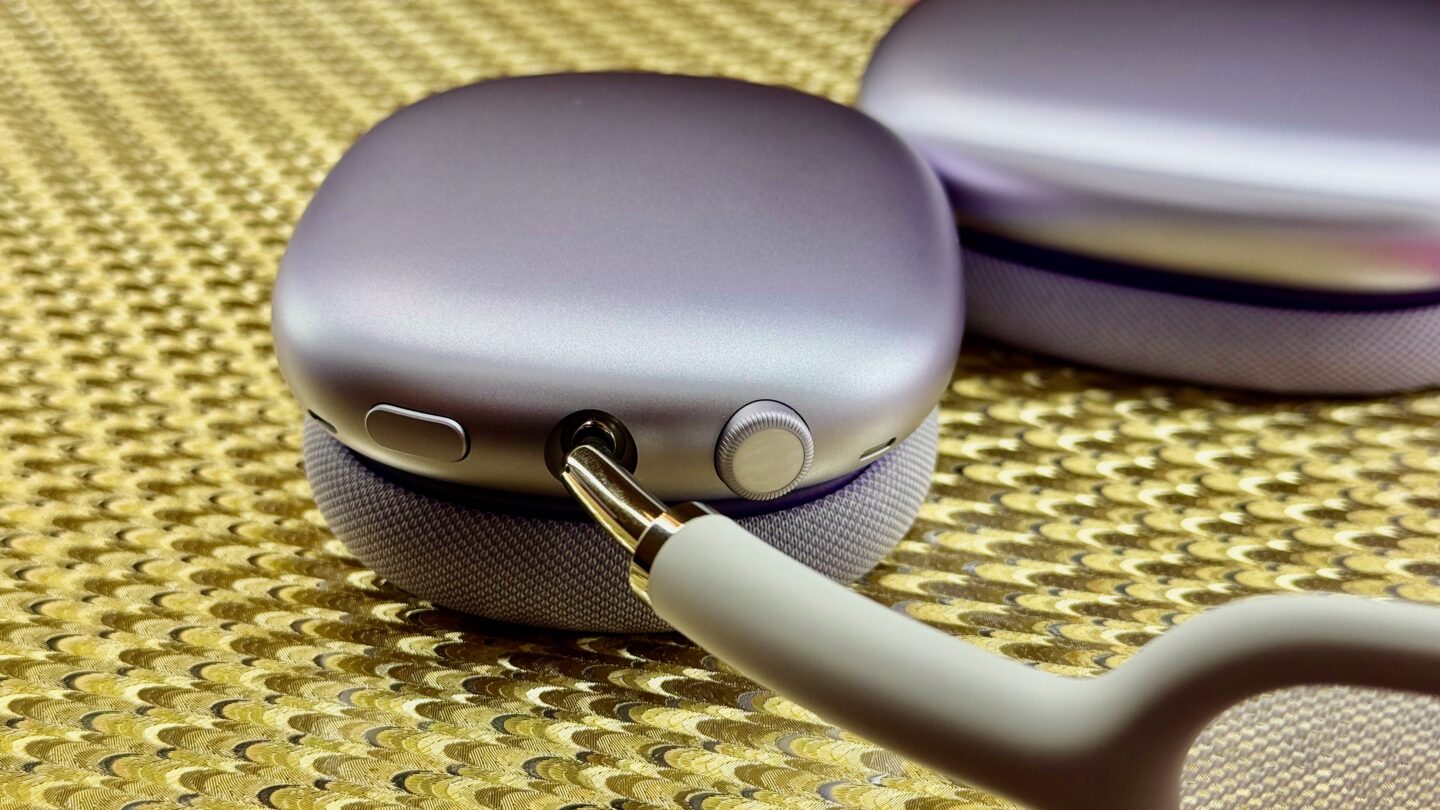 Purple AirPods Max 2 close up on a shiny gold background