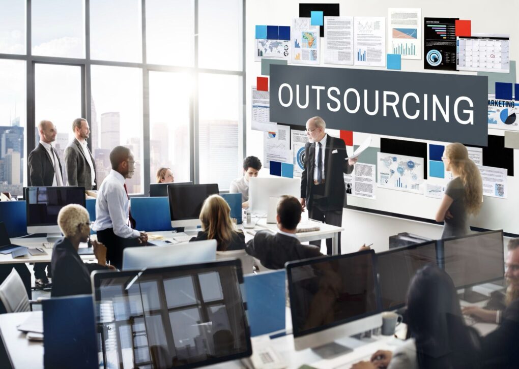 A businessman giving a talk about outsourcing.