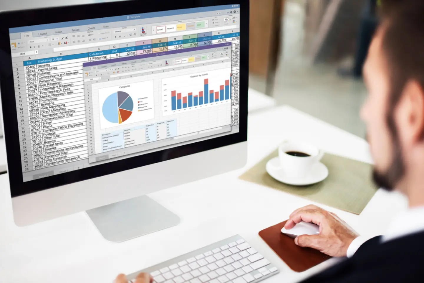 Man using excel on a Mac, used to illustrate a post about Microsoft Office 2024 Home & Business for Mac or PC deal with training bundle