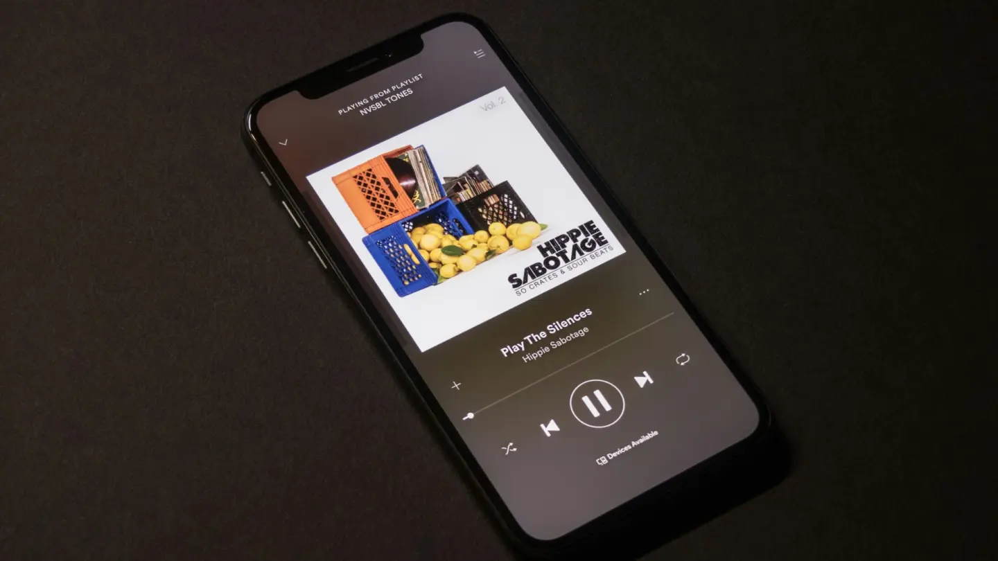 A photo of the Spotify app playing music on an iPhone.