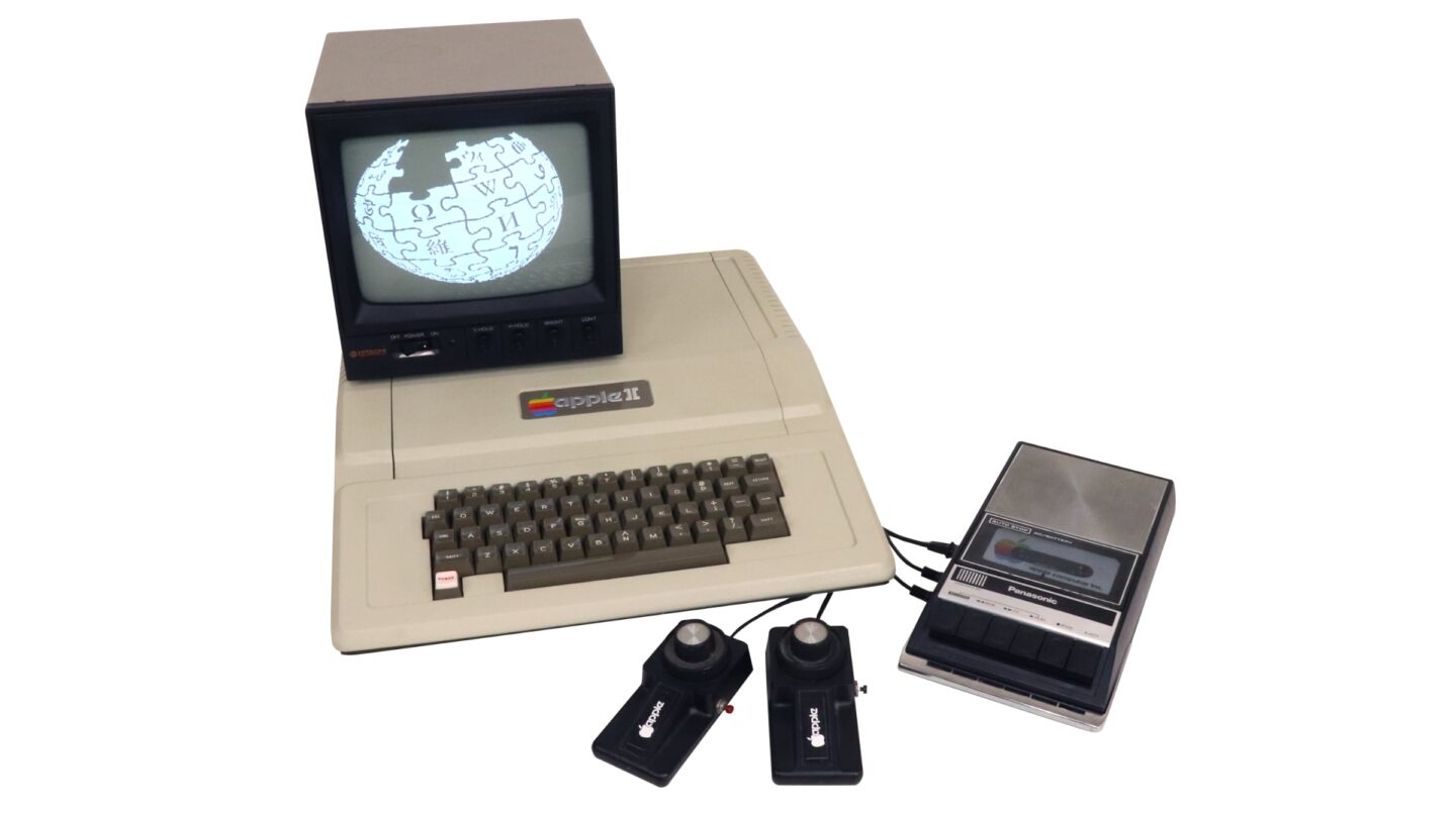 Photo of original Apple II computer with monochrome monitor, game controllers and cassette tape drive