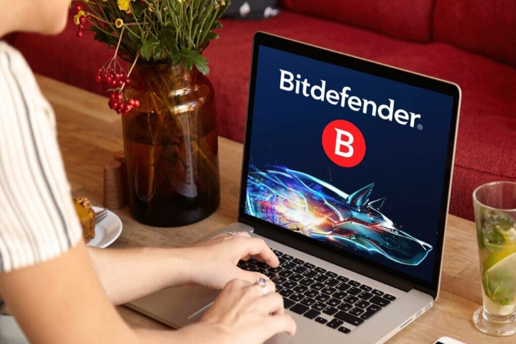 Bitdefender on the screen of a laptop of a person working on the couch