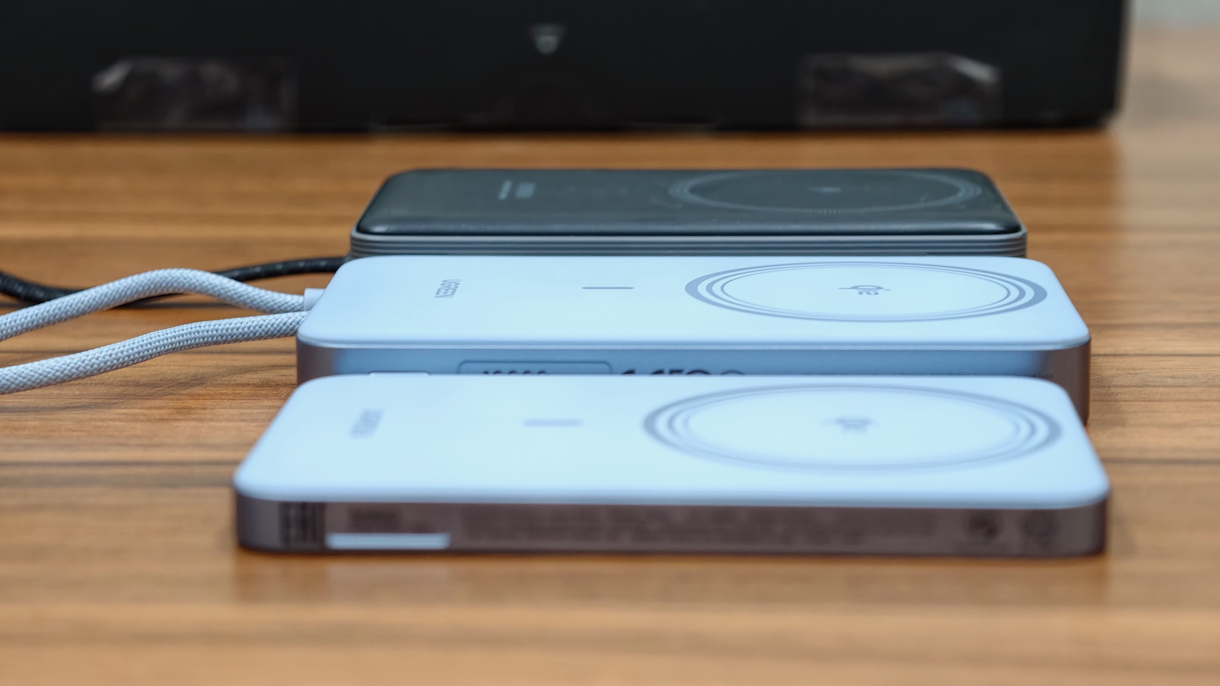 Ugreen MagFlow Air power banks next to a 10,000mAh power bank.