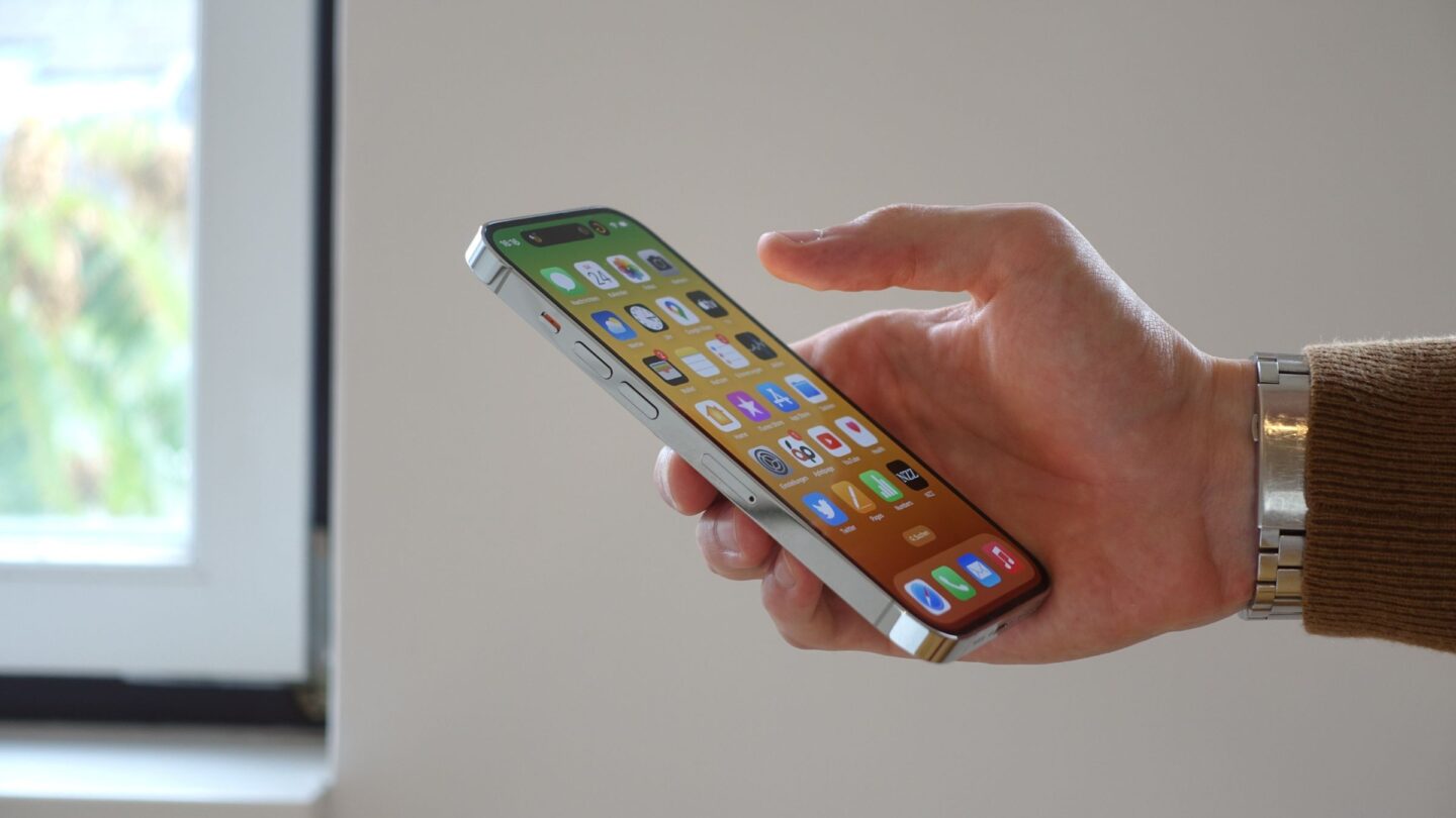 A photo showing an iPhone in a person's hand used in a story about iPhone price increase.