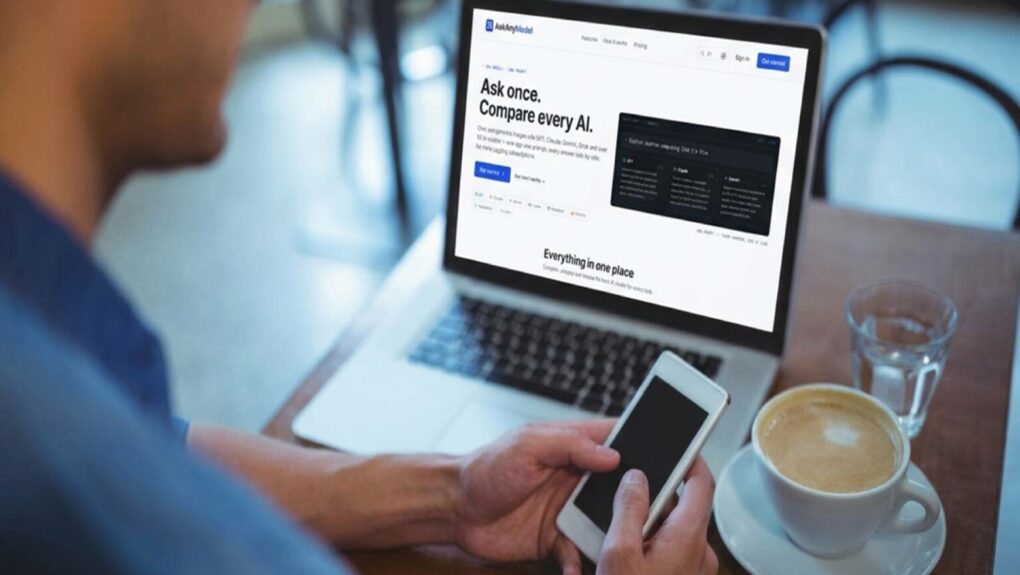A man working at a cafe with his laptop and mobile device, using multi-AI platform AskAnyModel