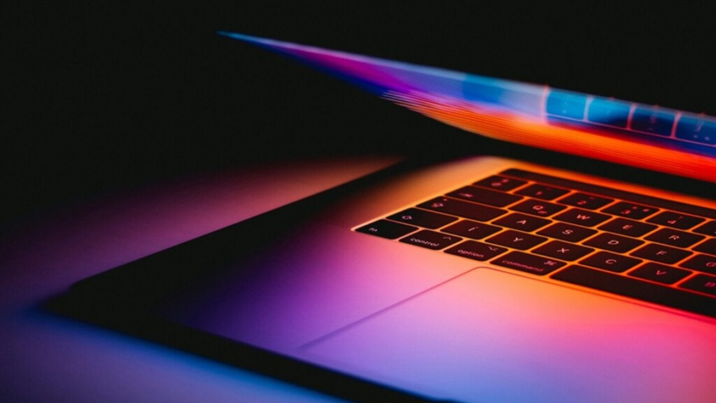 A MacBook in a dark room, used to promote The Secure Software Lifetime Mac Bundle featuring CleanTwin