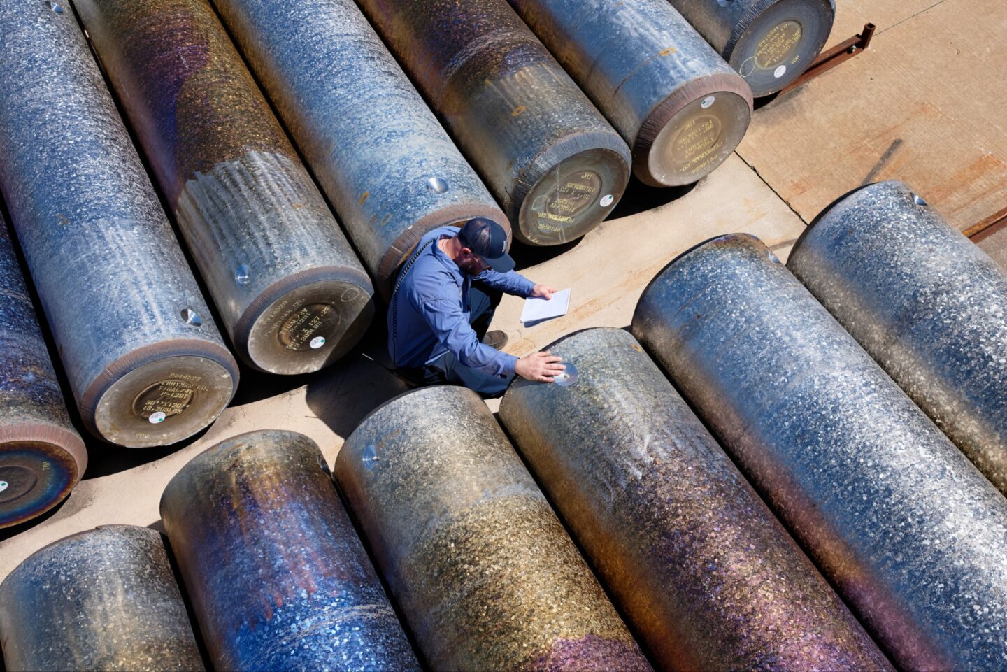 Apple titanium stock Photo of employee looking at massive pieces of titanium stock.