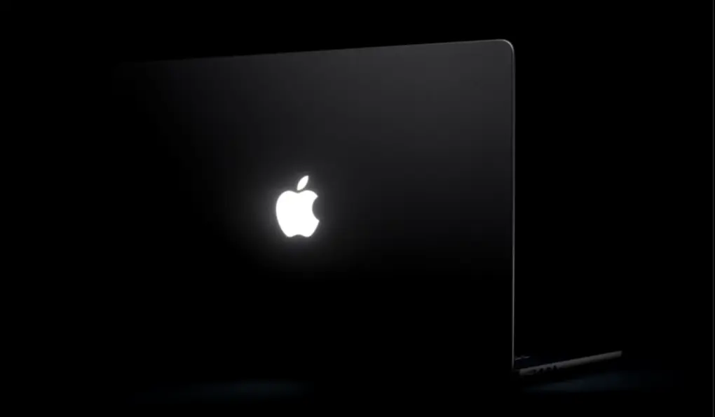 Glowing Apple logo on touchscreen MacBook Pro.